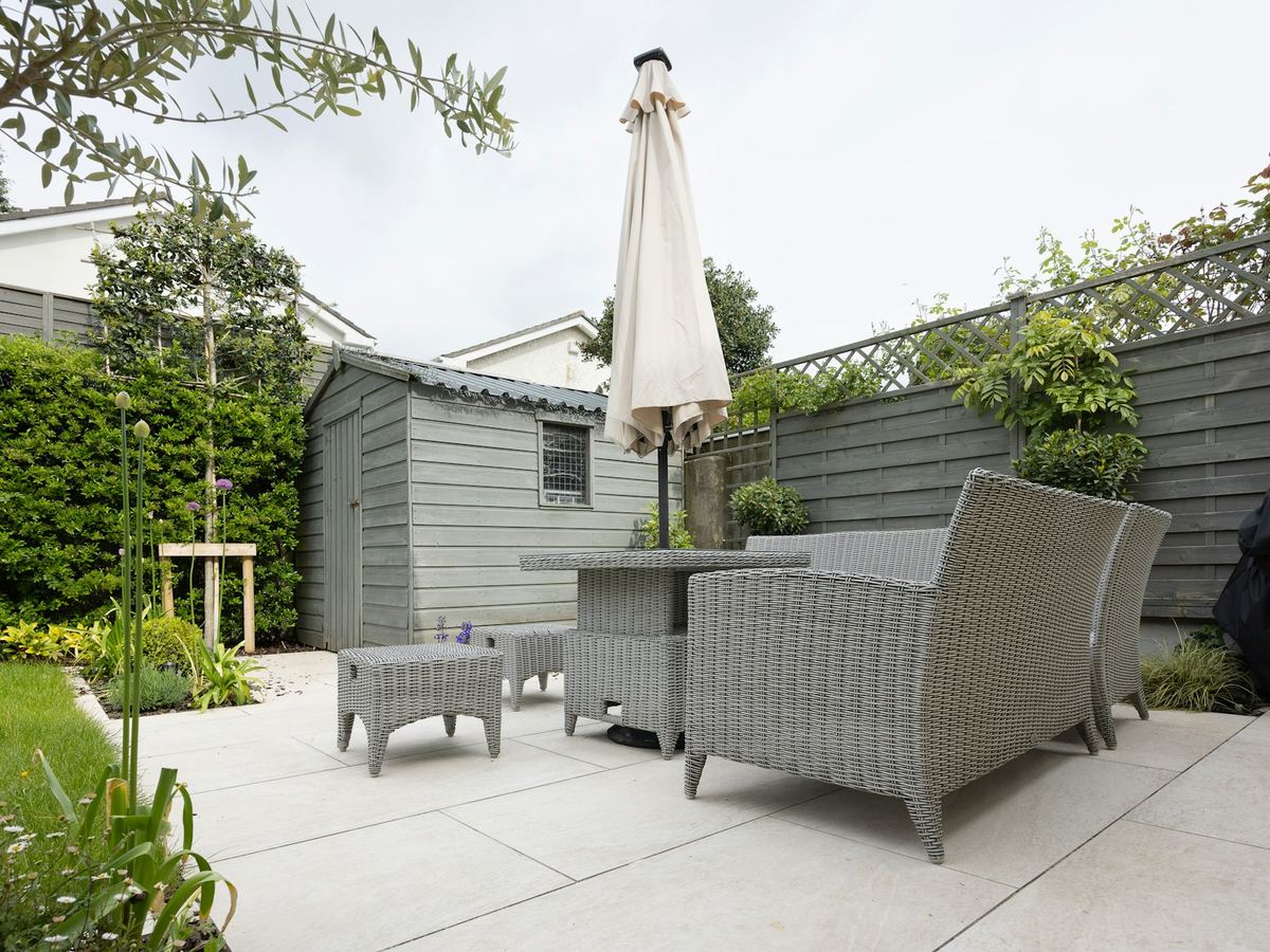Patio dining set with an umbrella in a garden