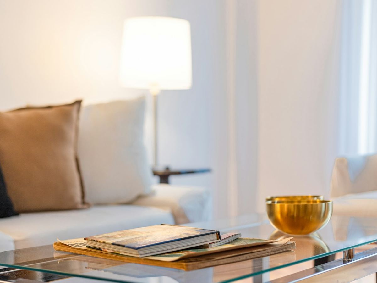 Rectangle glass coffee table with books in a living room